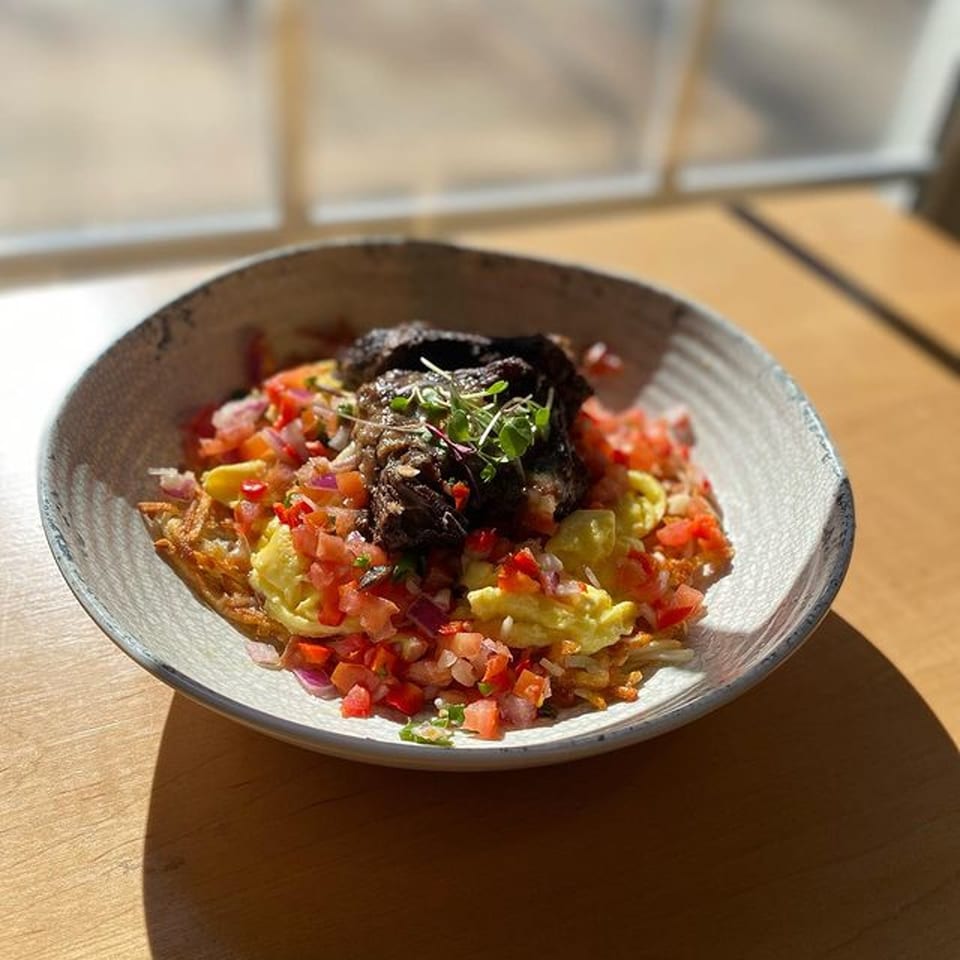 Good Kitchen's healthy breakfast bowl with hash browns, scrambled eggs, pico de gallo, and braised short rib.